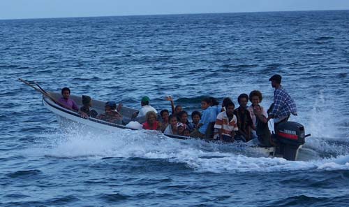 22 people riding in an outboard "banana boat"