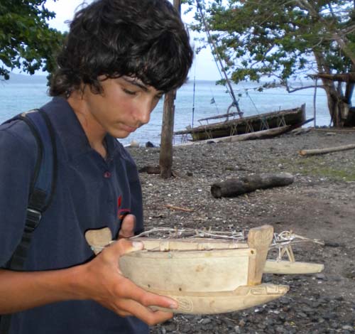 Aladin holding a scale replica of a Panapompom sailing canoe