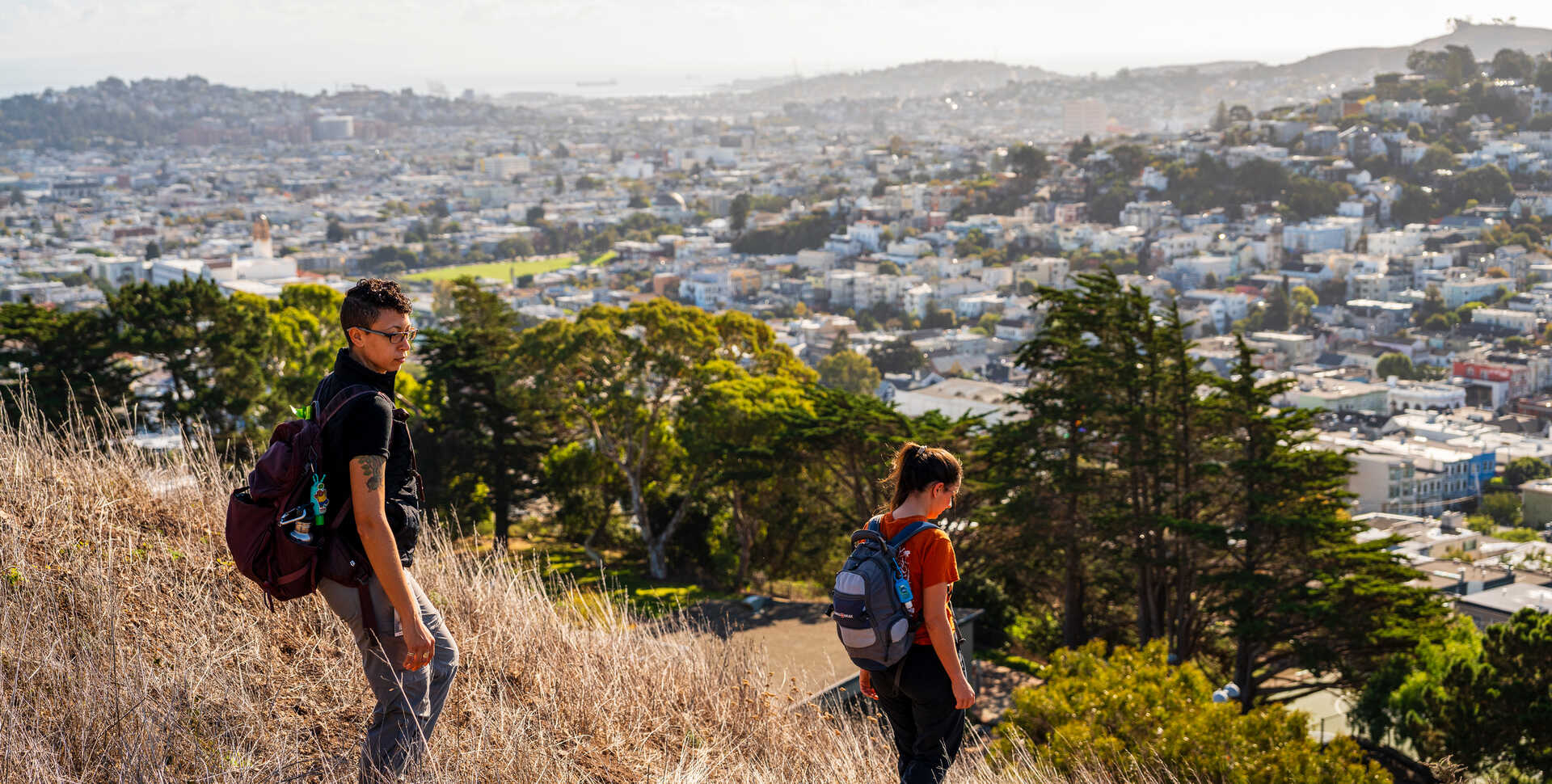 Urban ecologists Christine Wilkinson and Tali Caspi look for coyotes on Bernal Hill in San Francisco. Photo by Gayle Laird