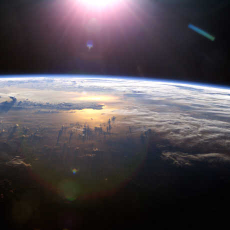 Sun over Earth from the ISS, 2013; NASA