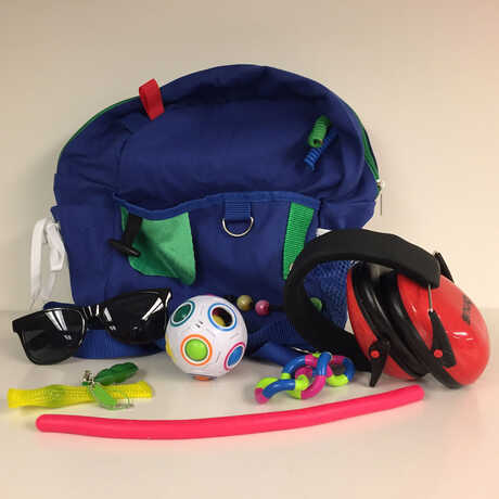 Sensory bags with headphones, sunglasses, and fidget toys
