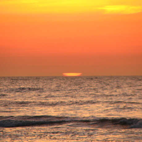 Mirage of the sun at the horizon over the ocean
