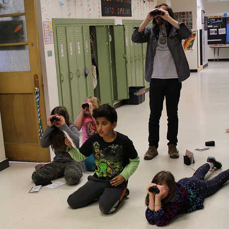 SAC members using binoculars 