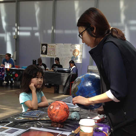 A young visitor learns about planets