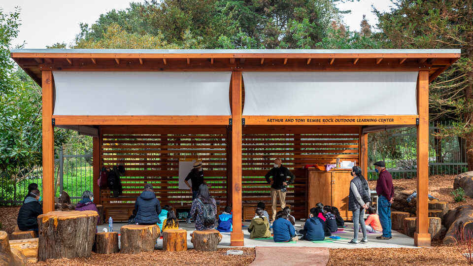 Educators teach a class in the new outdoor learning space in Wander Woods.