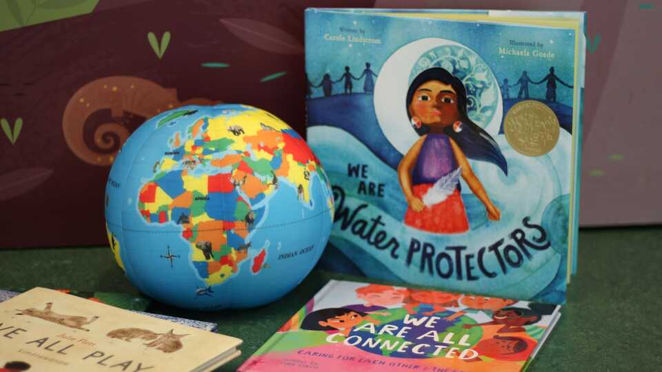 Display of toy globe and children's books