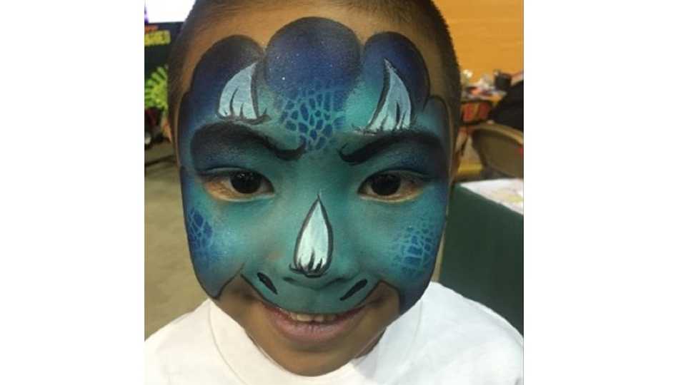 Child in Dinosaur face paint