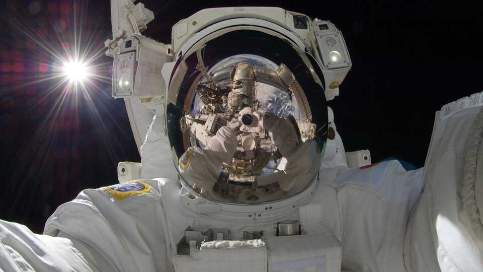 Astronaut selfie in space with reflective helmet visor